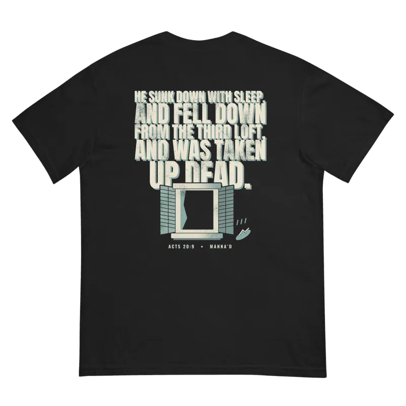 Back of a black Manna’d tee printed: HE SUNK DOWN WITH SLEEP, AND FELL DOWN FROM THE THIRD LOFT, AND WAS TAKEN UP DEAD. (Acts 20:9)