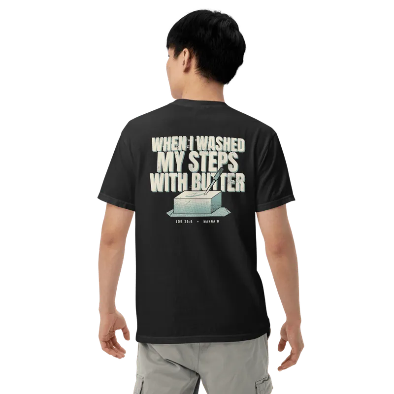 Back of a black Manna’d tee printed: WHEN I WASHED MY STEPS WITH BUTTER (Job 29:6)