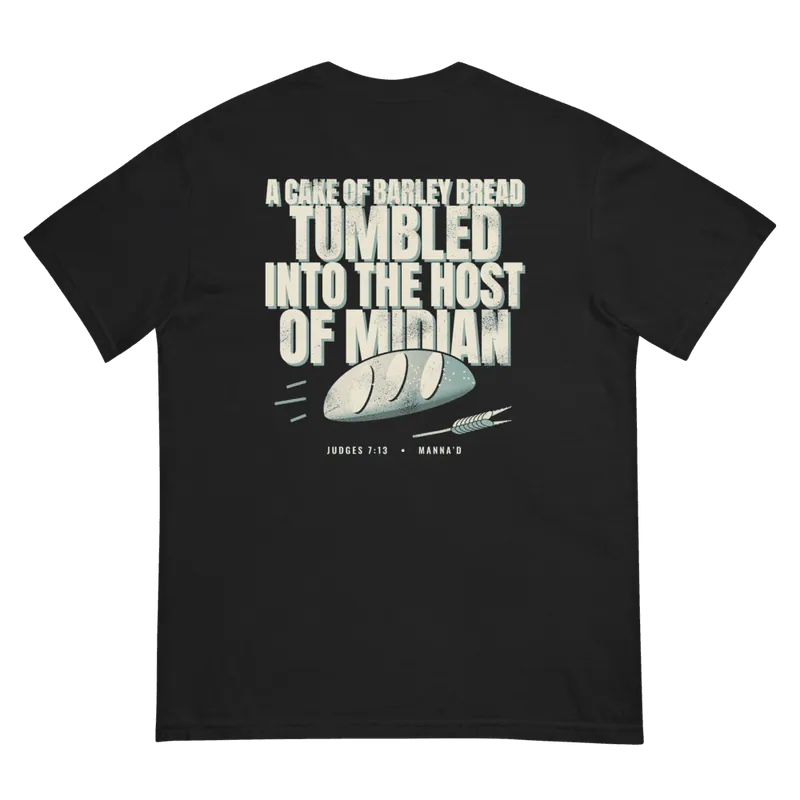 Back of a black Manna’d tee printed: A CAKE OF BARLEY BREAD TUMBLED INTO THE HOST OF MIDIAN (Judg 7:13)