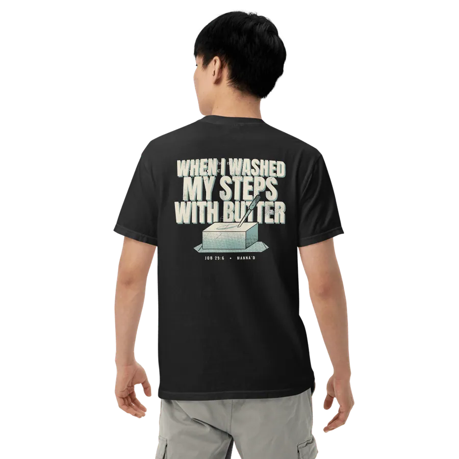 Model wearing the black Manna’d tee, back printed WHEN I WASHED MY STEPS WITH BUTTER (Job 29:6)