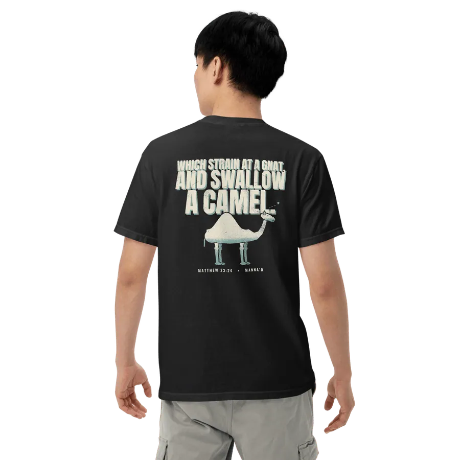 Model wearing the black Manna’d tee, back printed WHICH STRAIN AT A GNAT, AND SWALLOW A CAMEL. (Matt 23:24)